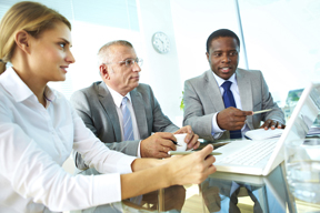 Image of business men and women at a meeting