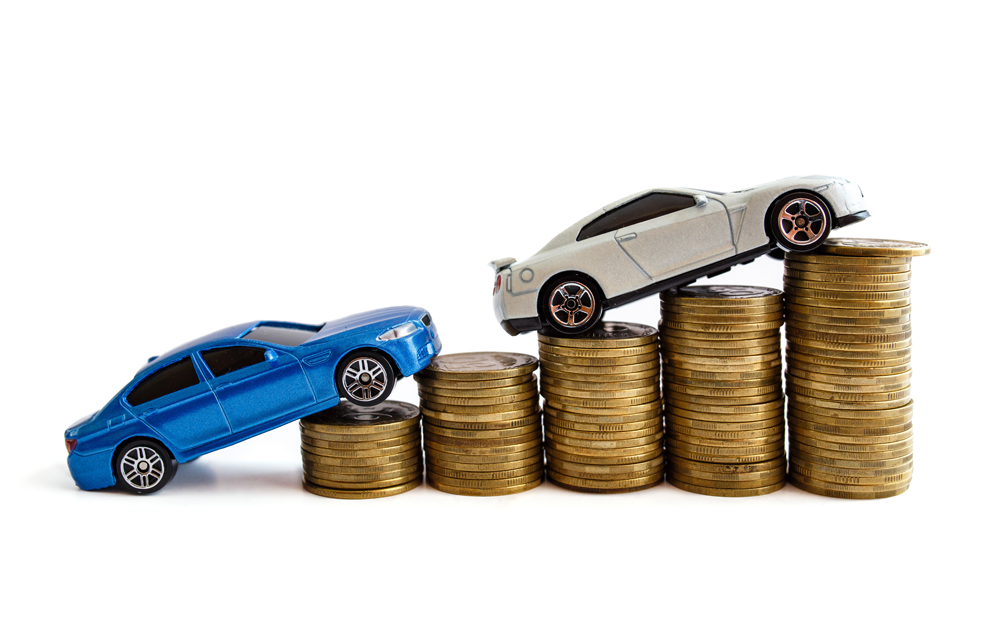 A blue and white toy car on a stack of coins