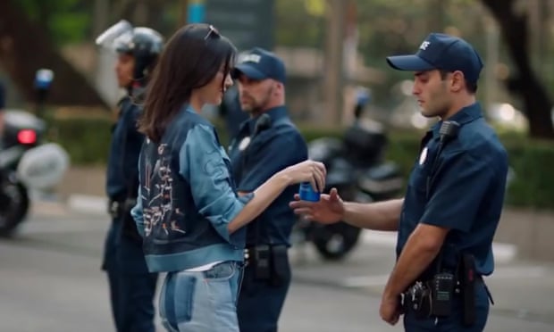 Pepsi ad featuring reality star Kendall Jenner walking into the middle of a protest and saves the day with a soda.