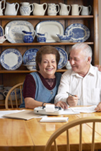 retired couple sitting at kitchen table