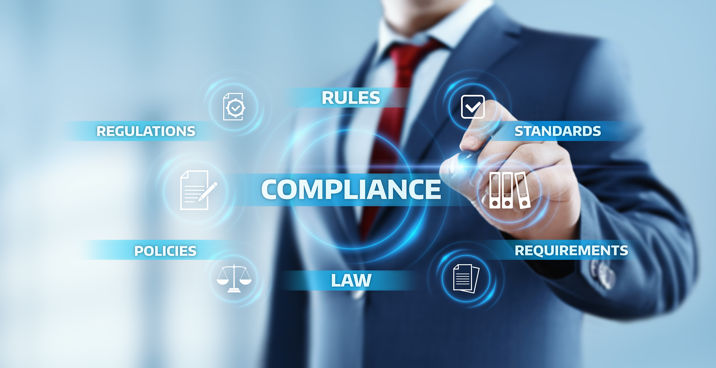 A man touching a screen with words including Compliance, Regulations, Rules, Standards, Policies, Law, and Requirements.