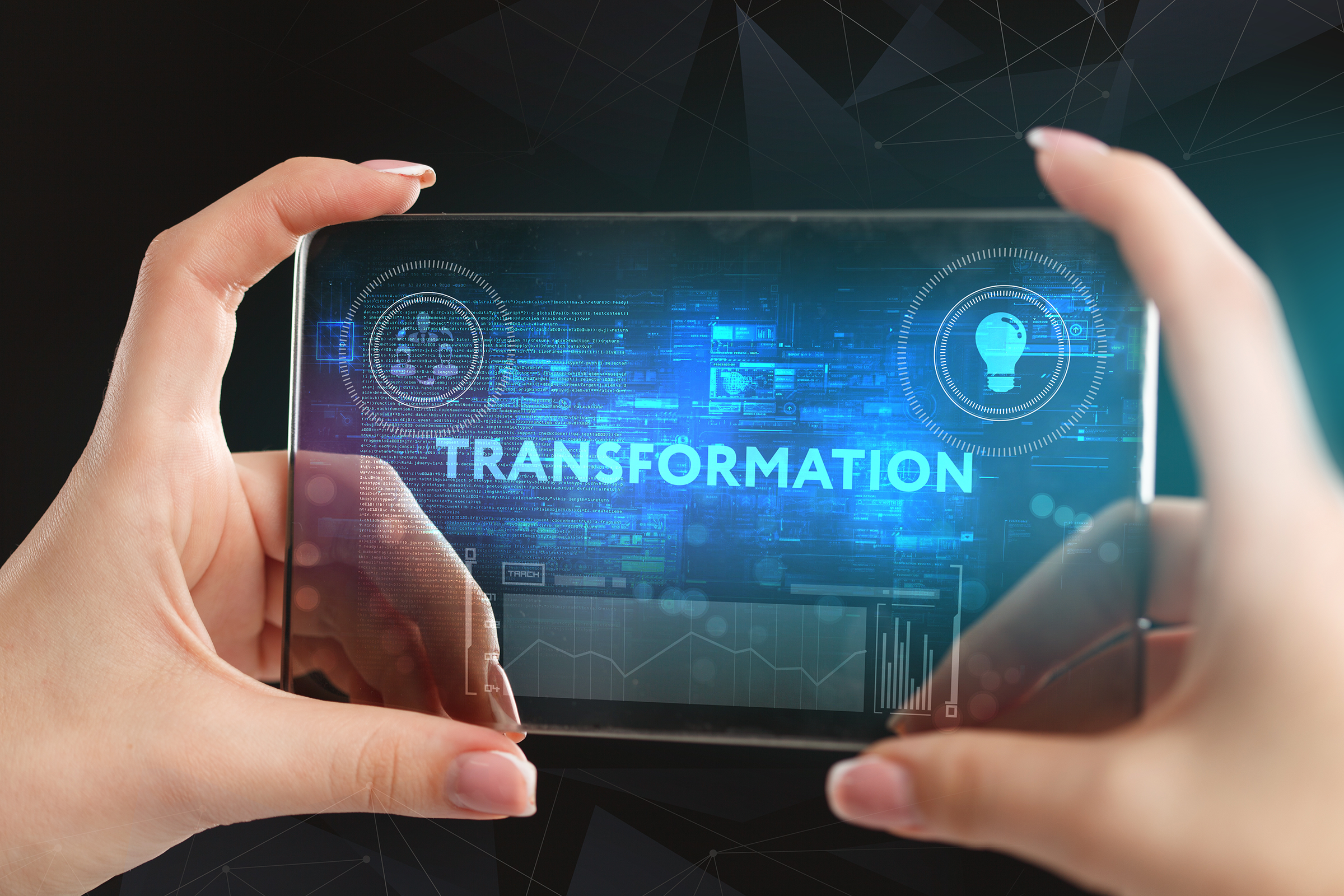 A young entrepreneur working on a virtual screen of the future and sees the inscription: Transformation