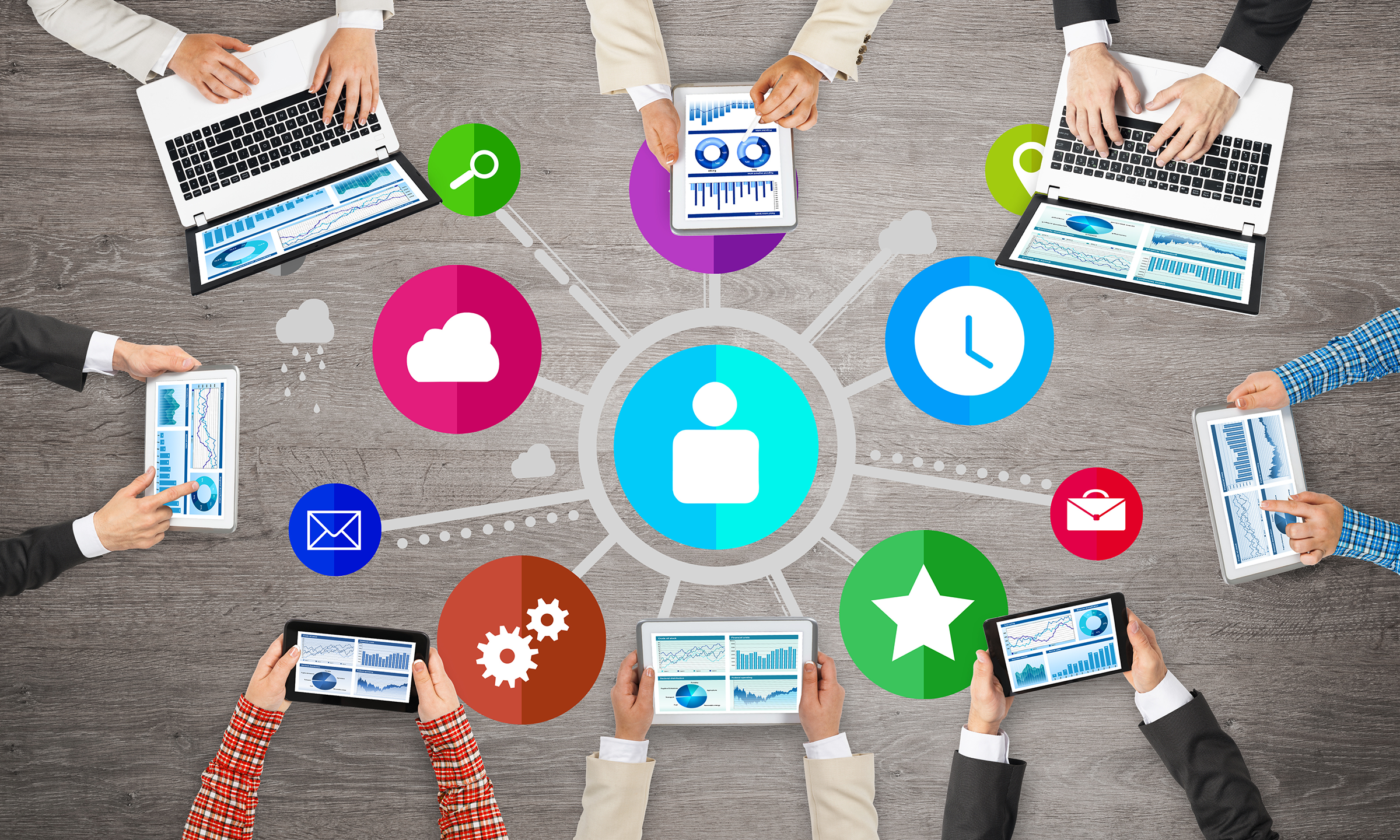Top view of businesspeople sitting at table and using laptops and tablets