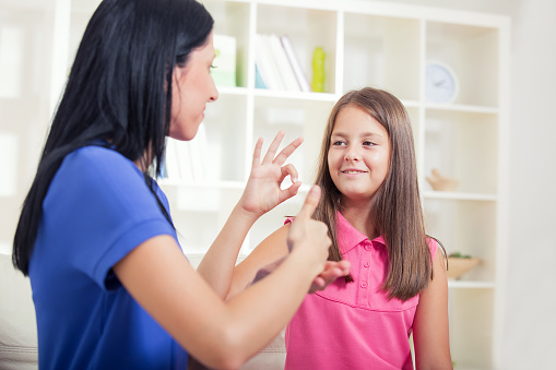 Deaf woman and child learning sign language